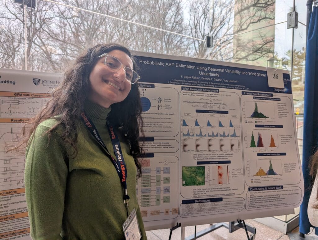 ARROW student Başak Rakıcı stands in front of her research poster at the ROSEI summit