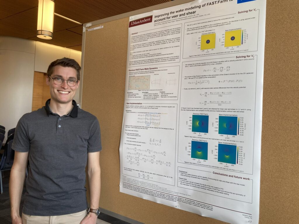 Jonah Hanak stands with his poster at the Energy Transition Symposium